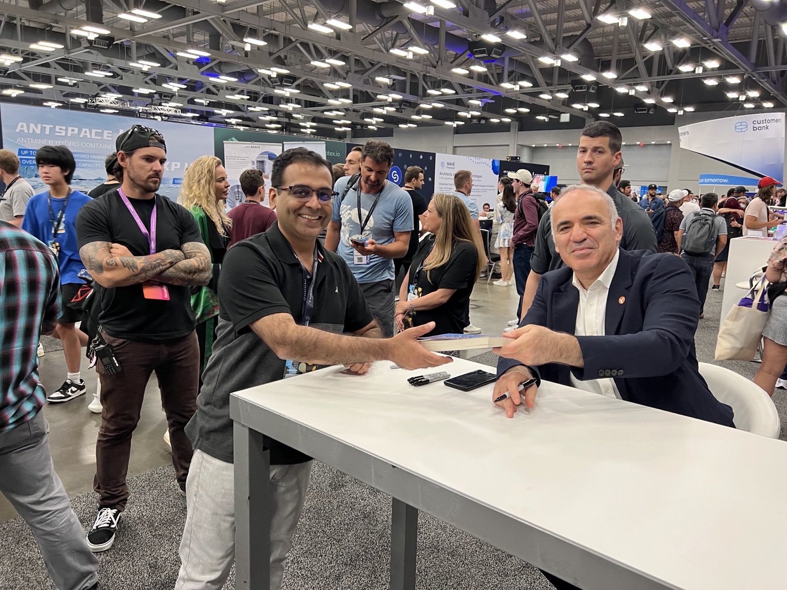 Bhairav Kothari receiving a signed copy of Deep Thinking from Garry Kasparov